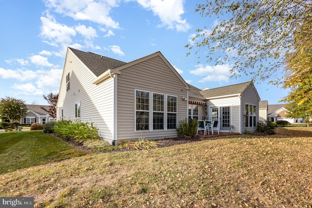 back of property featuring a lawn