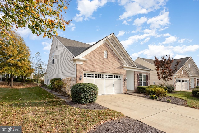 view of front of property with a garage and a front lawn