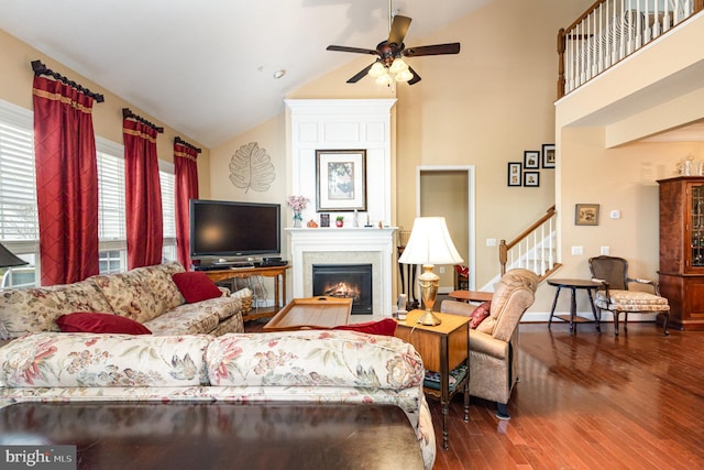 living room featuring vaulted ceiling, ceiling fan, and wood-type flooring