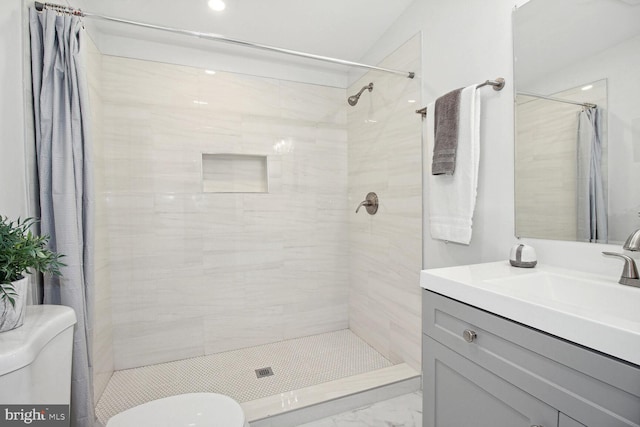 bathroom featuring vanity, toilet, and walk in shower