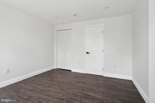 unfurnished bedroom with dark hardwood / wood-style floors