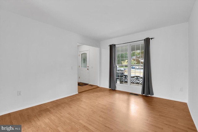 unfurnished room with hardwood / wood-style floors