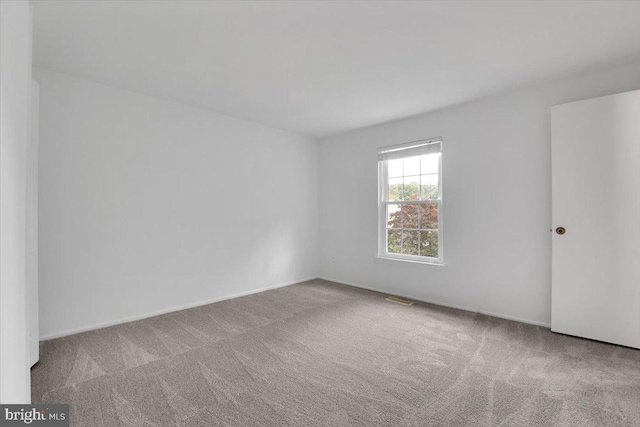 unfurnished room featuring light colored carpet