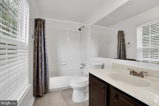 full bathroom featuring plenty of natural light, toilet, shower / bath combo, and vanity