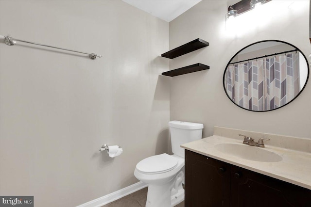 bathroom featuring tile patterned flooring, vanity, and toilet