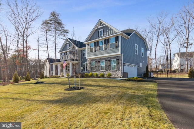 view of front of house with a front yard and a garage