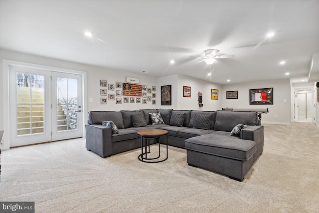 carpeted living room with ceiling fan