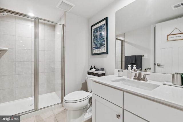 bathroom featuring vanity, tile patterned flooring, toilet, and an enclosed shower