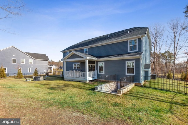 rear view of property with a lawn and a deck