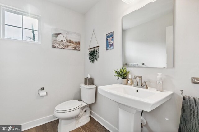 bathroom featuring hardwood / wood-style floors and toilet