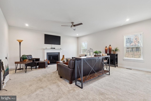 living room with ceiling fan and light colored carpet