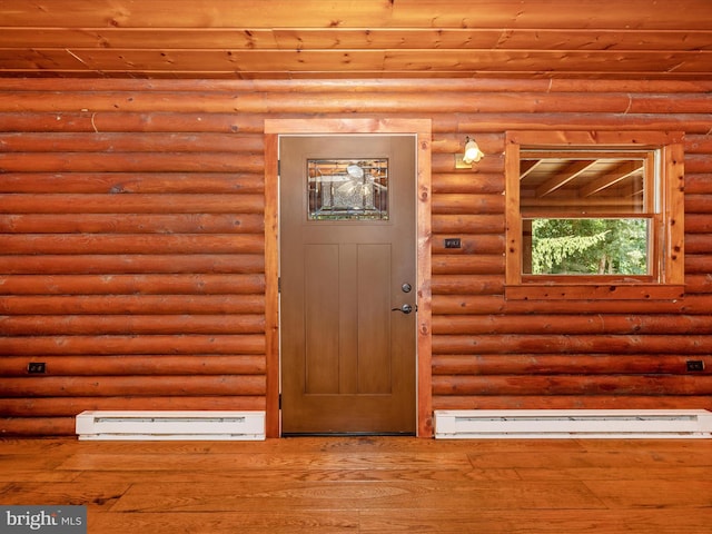 property entrance featuring a baseboard heating unit