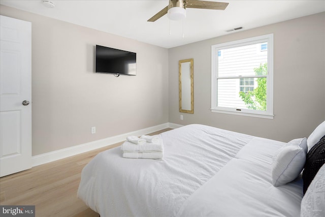 bedroom featuring light wood-type flooring and ceiling fan