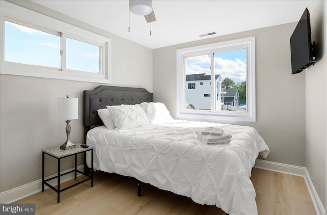 bedroom with ceiling fan and hardwood / wood-style floors