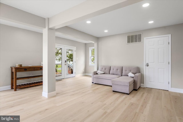 living room featuring french doors and light hardwood / wood-style flooring