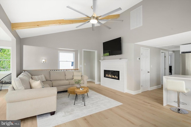 living room featuring high vaulted ceiling, light wood-type flooring, and ceiling fan