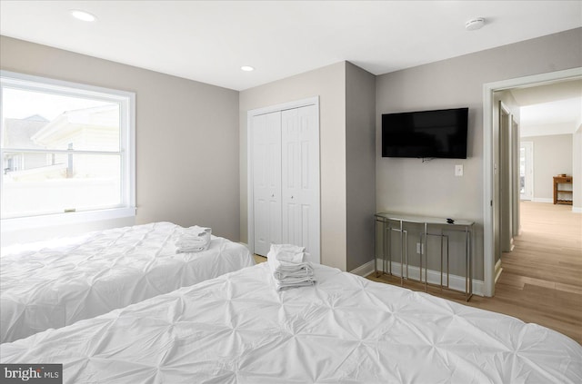 bedroom featuring light wood-type flooring and a closet