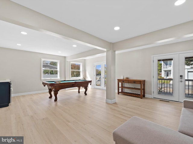 game room featuring a healthy amount of sunlight, french doors, and light hardwood / wood-style flooring