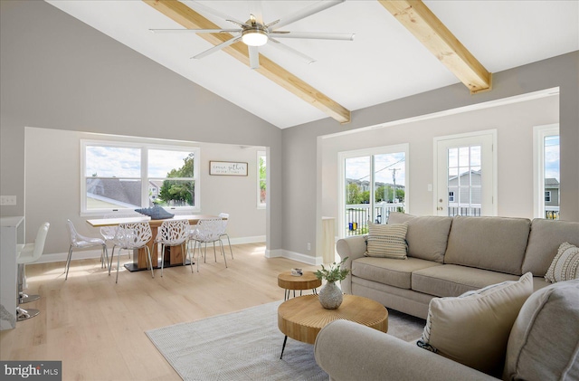 living room with ceiling fan, beamed ceiling, light hardwood / wood-style flooring, and high vaulted ceiling