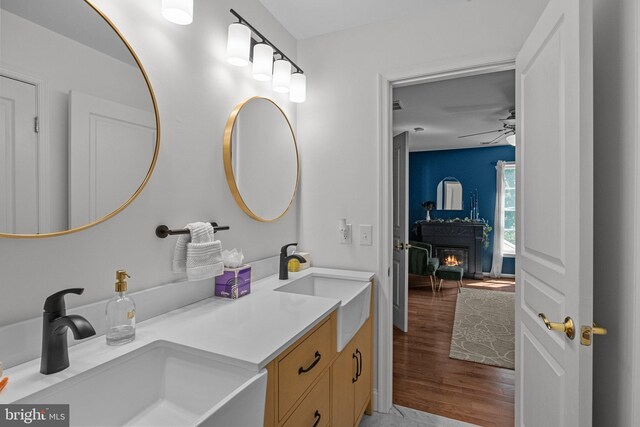 bathroom featuring vanity, hardwood / wood-style flooring, and ceiling fan