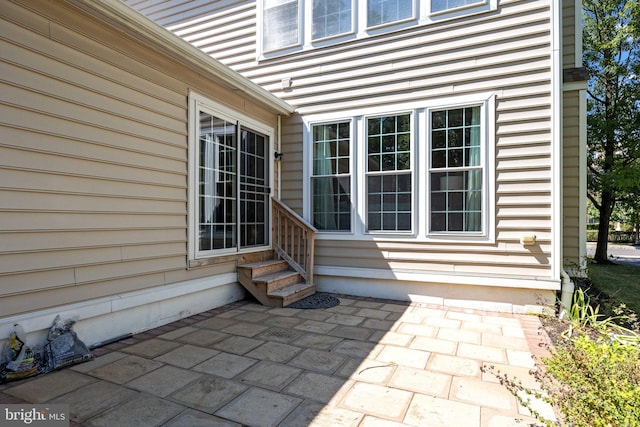 view of exterior entry featuring a patio area