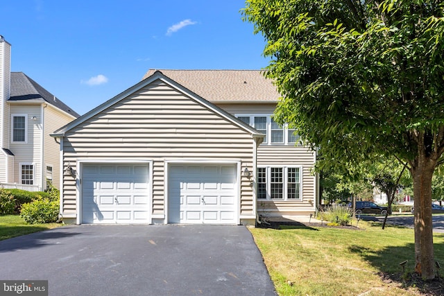 view of front of house featuring a front yard and a garage