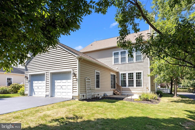 view of front facade with a front yard and a garage