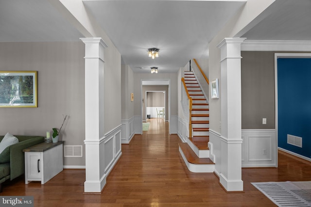 foyer entrance featuring ornate columns and hardwood / wood-style flooring