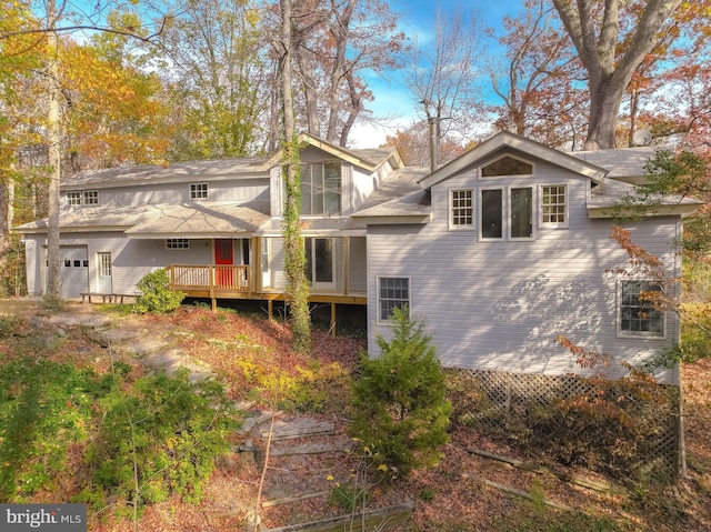 back of house featuring a deck