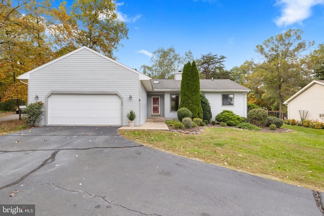 single story home with a front yard and a garage