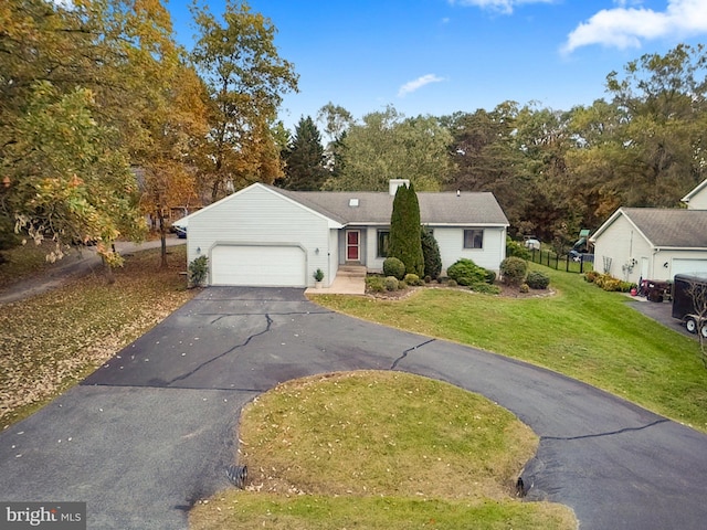 view of front of property with a front yard and a garage