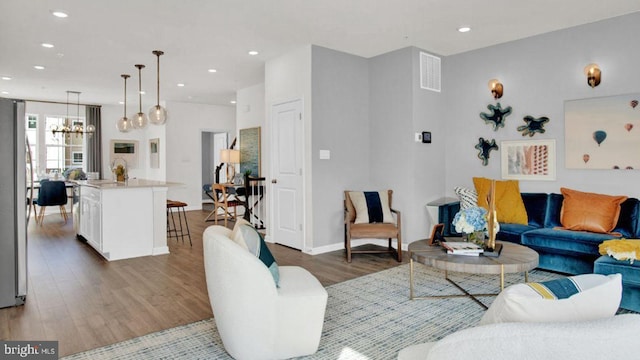 living room featuring a chandelier and dark hardwood / wood-style flooring