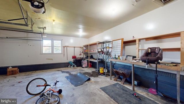 garage featuring a garage door opener and a workshop area