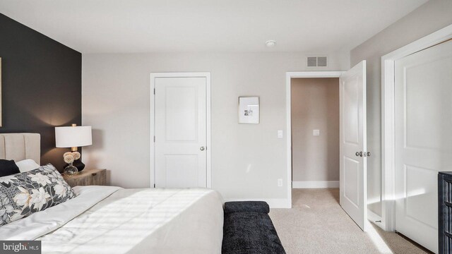 bedroom featuring light colored carpet