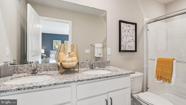 bathroom featuring walk in shower, vanity, and toilet