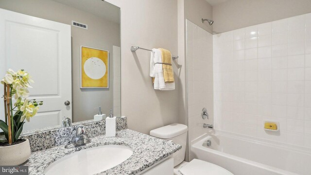 full bathroom featuring vanity, toilet, and tiled shower / bath