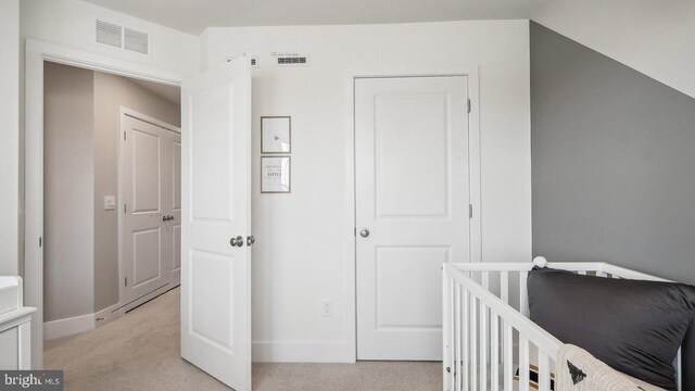 bedroom featuring light colored carpet