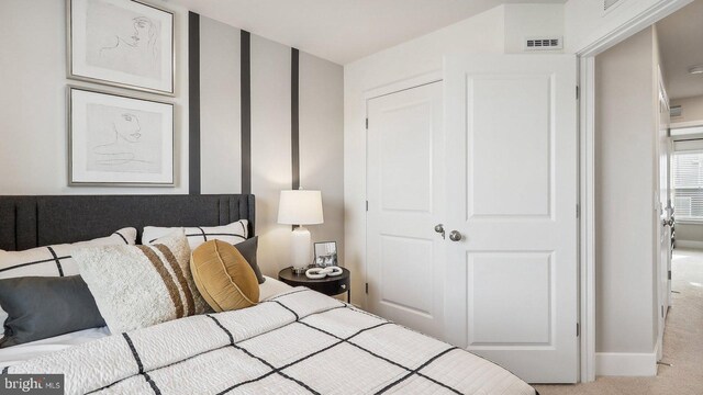 bedroom featuring light carpet and a closet