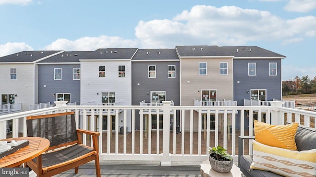 back of house featuring outdoor lounge area and a balcony