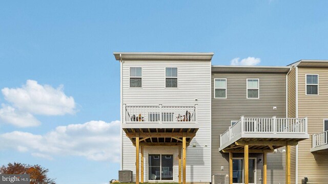 back of house featuring a deck and central AC unit