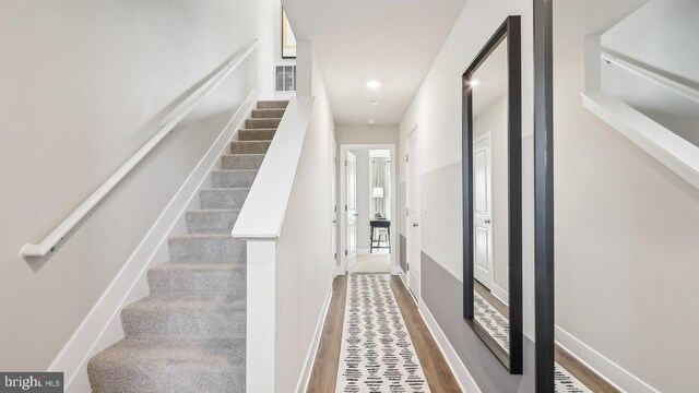 stairway featuring hardwood / wood-style floors