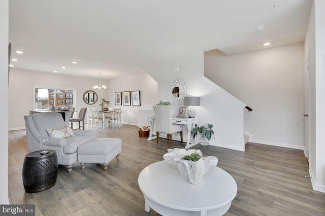 living room with an inviting chandelier and dark hardwood / wood-style floors