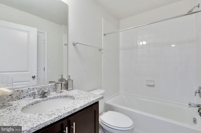 full bathroom with vanity, tiled shower / bath, and toilet