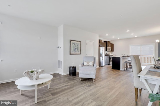 living room with light hardwood / wood-style flooring