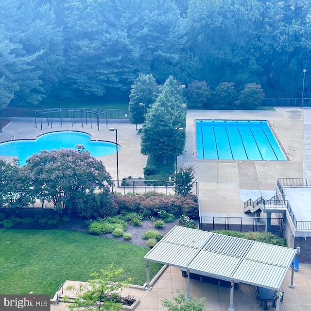 view of swimming pool with a patio area