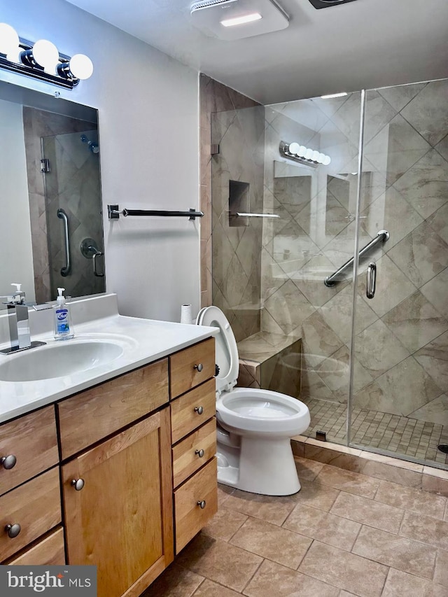 bathroom with toilet, vanity, and walk in shower