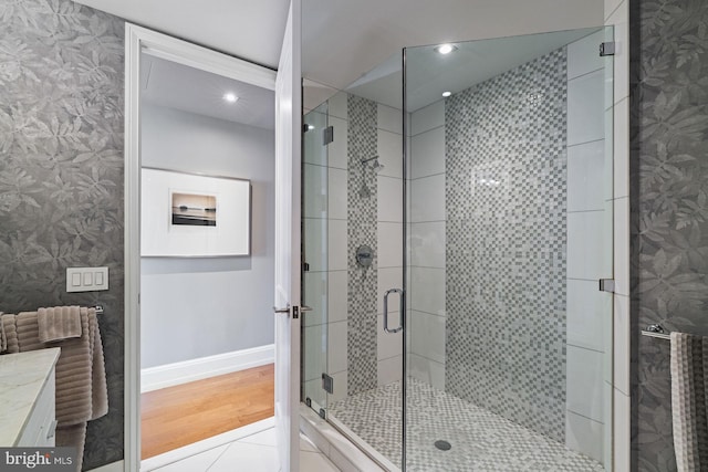 bathroom featuring vanity, wood-type flooring, and an enclosed shower