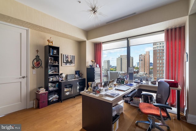 office space with light hardwood / wood-style floors