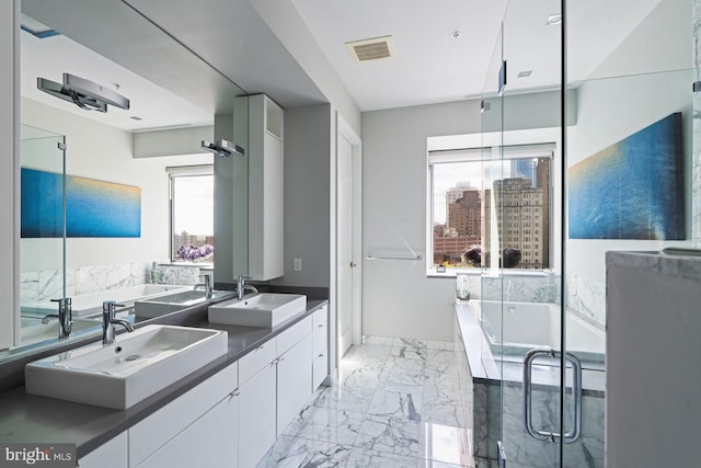 bathroom with vanity and independent shower and bath