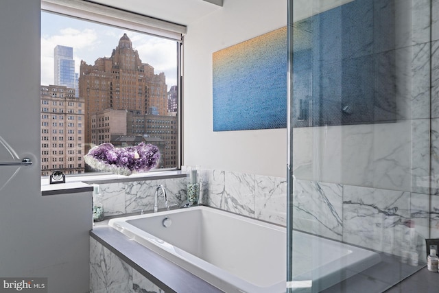 bathroom featuring tiled tub